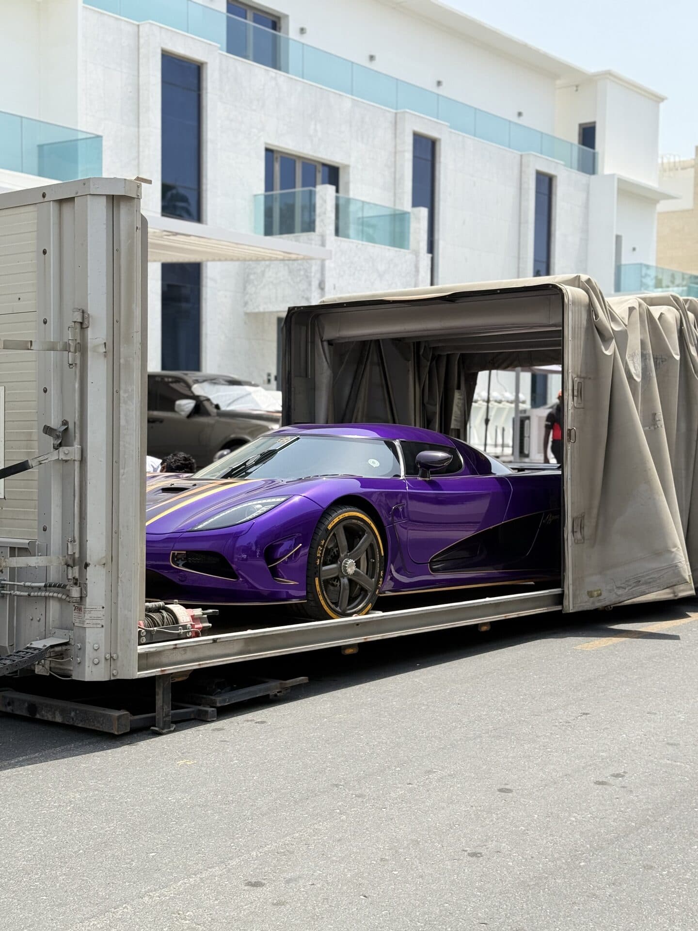 TAS Car Towing enclosed covered recovery trailer loading a purple hypercar in Dubai