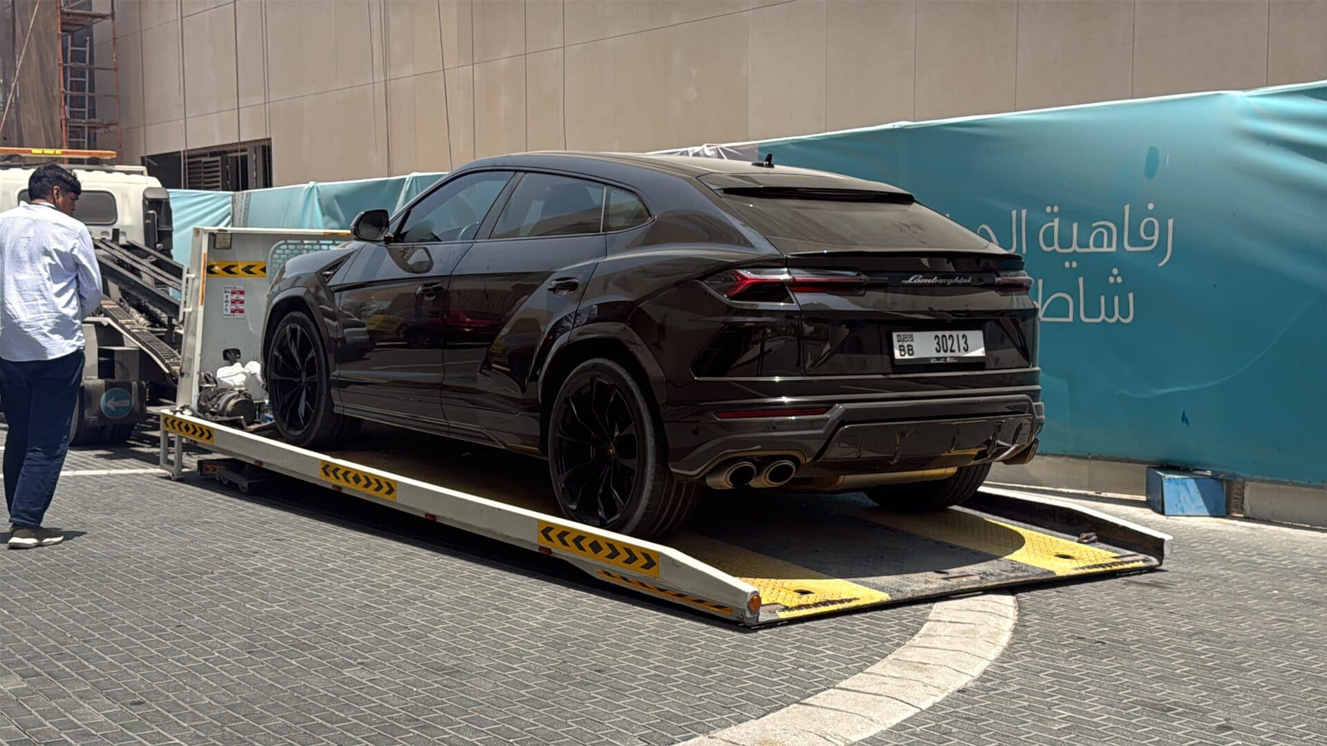 TAS Car Towing recovery truck loading a black Lamborghini Urus in Dubai