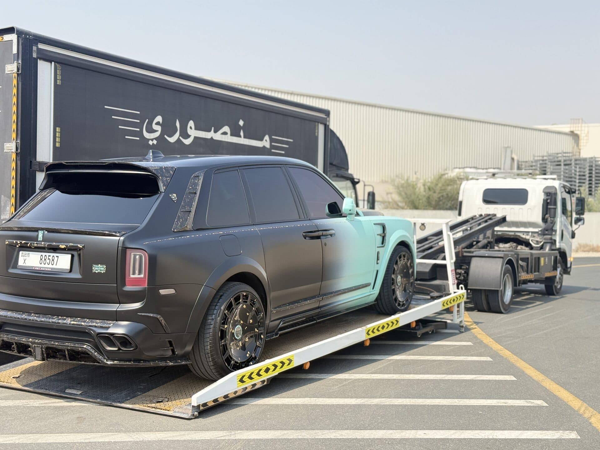 TAS Car Towing flatbed truck carrying a modified Rolls-Royce Cullinan in Dubai